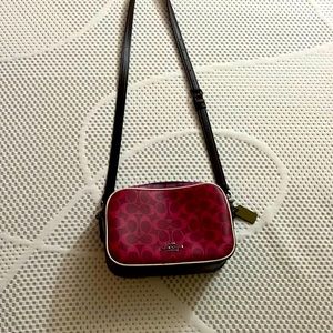 This is a vibrant purple coach crossbody